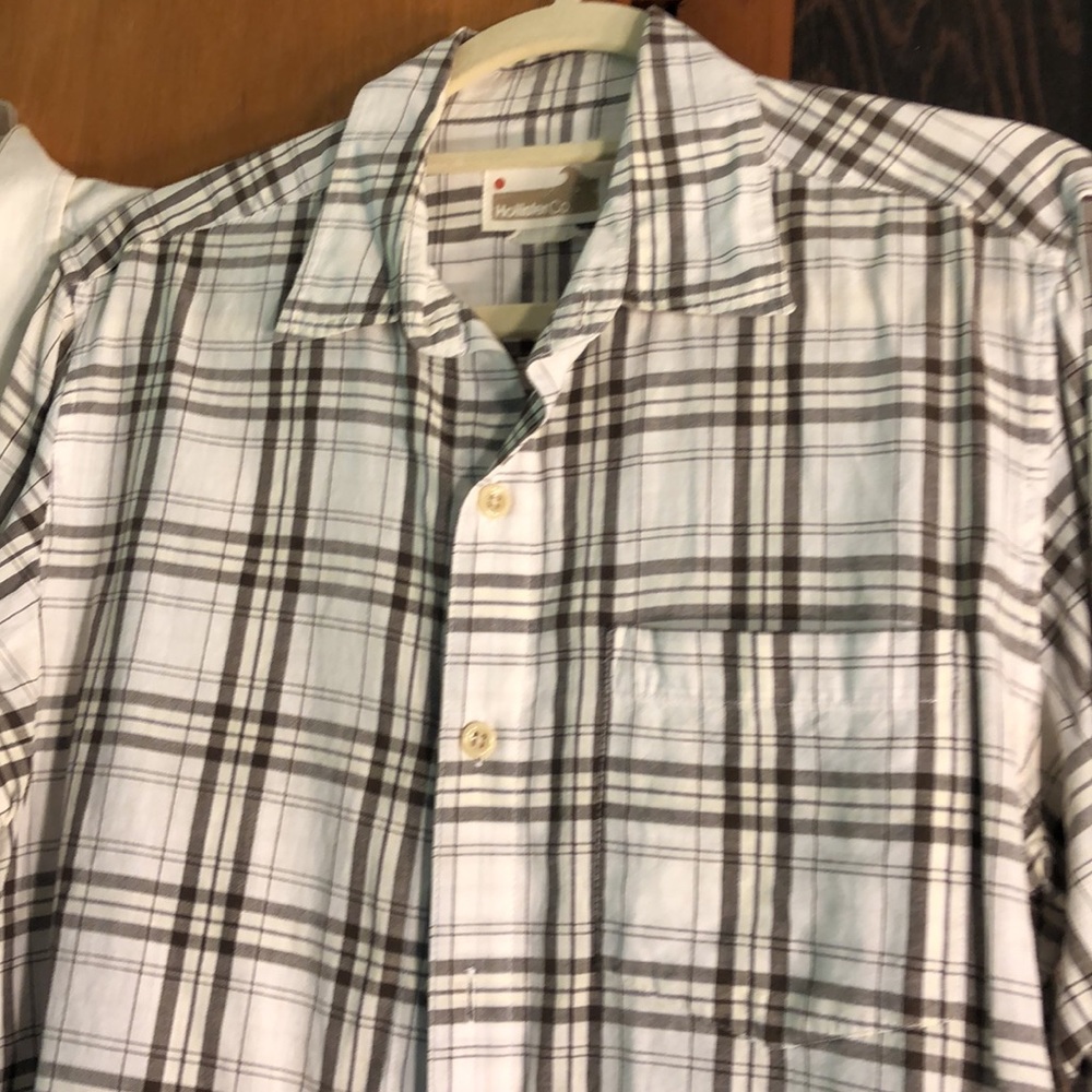 2 Hollister button down Shirts.  2 plaid shirts. Shirt in the middle not avail